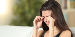 Woman rubbing eyes
