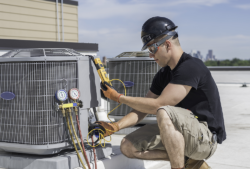 technician performing HVAC maintenance