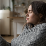 woman wrapped in a blanket inside