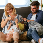parents playing on couch with toddler