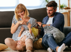 parents playing on couch with toddler