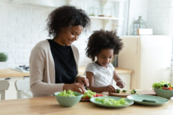 mother and daughter making food in a ktichen