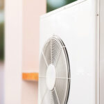 technician fixing a heat pump