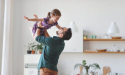 man lifting daughter