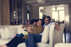 a family relaxes on a couch together
