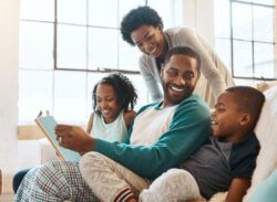 a mother and father spend time with their children on their couch in Auburn, IN