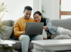 A couple checking their laptop while waiting for Air Conditioniong Tune Up in Huntertown, IN